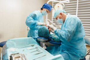 Oral surgery team carefully working on patient